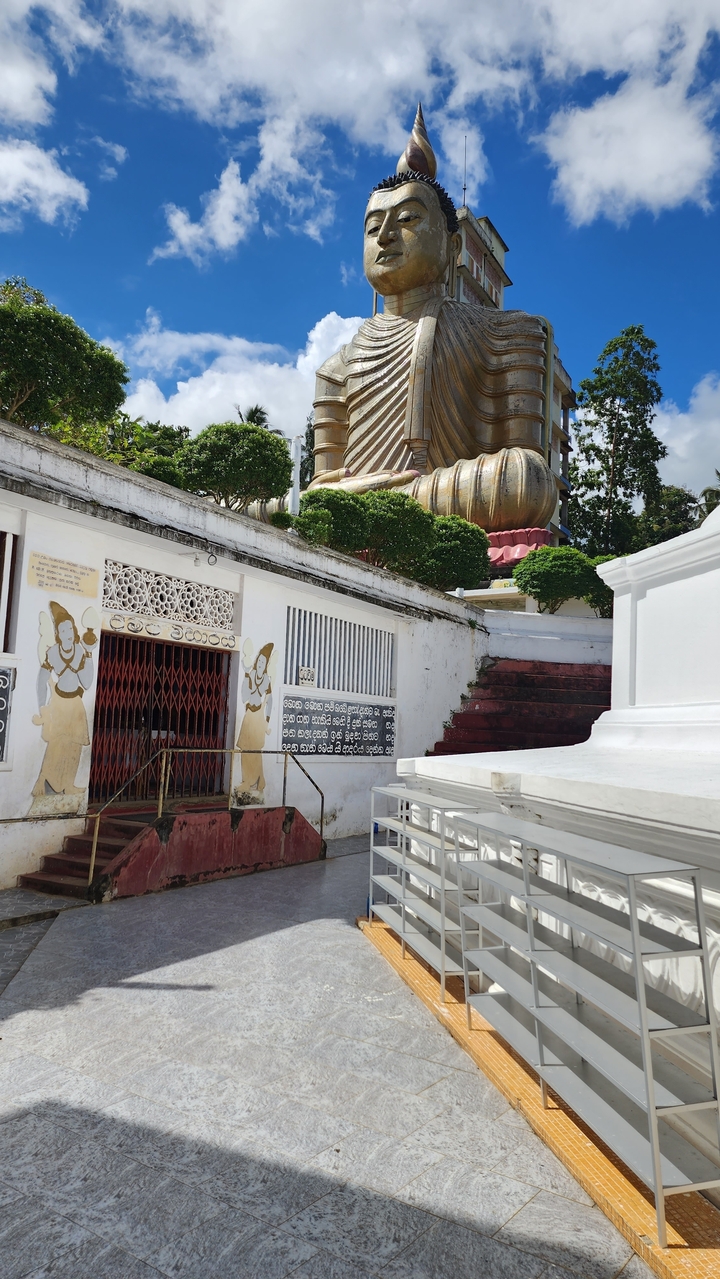 A temple with large statues and decorative elements.