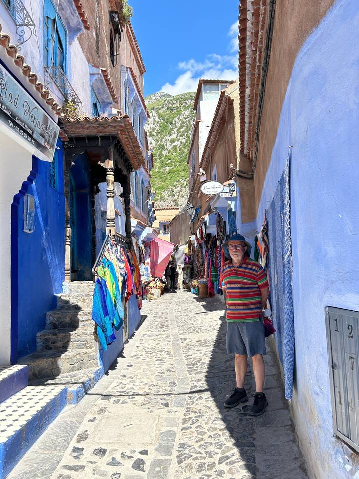 Person standing in a colorful market street.