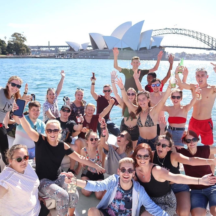 Group of people partying on a boat in the harbor.