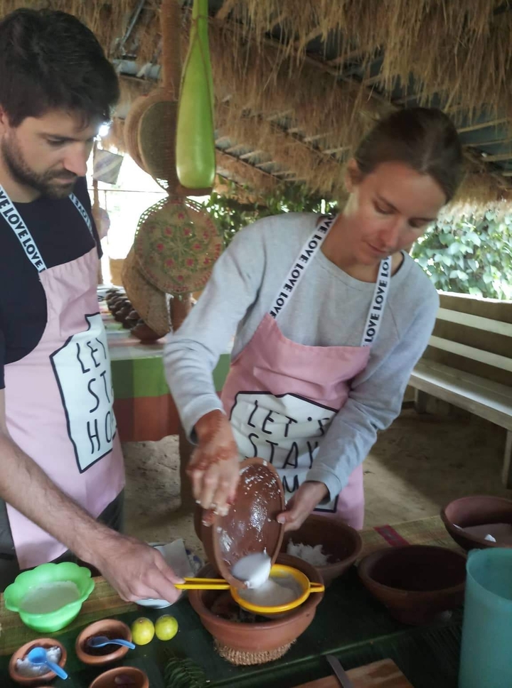 Person participating in a cooking activity, wearing an apron.