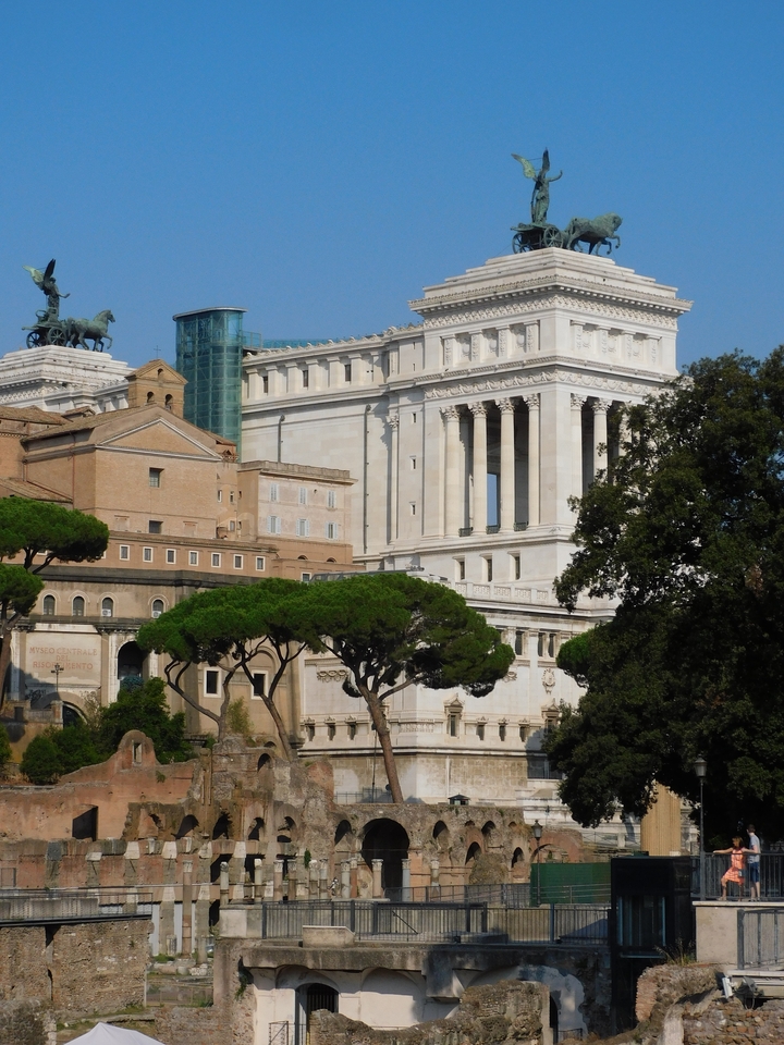 Close-up view of a white monumental building with trees