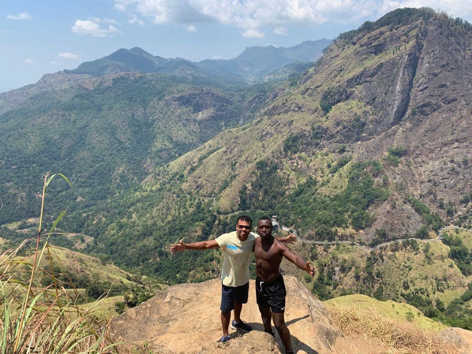 Two people posing on a mountain summit.