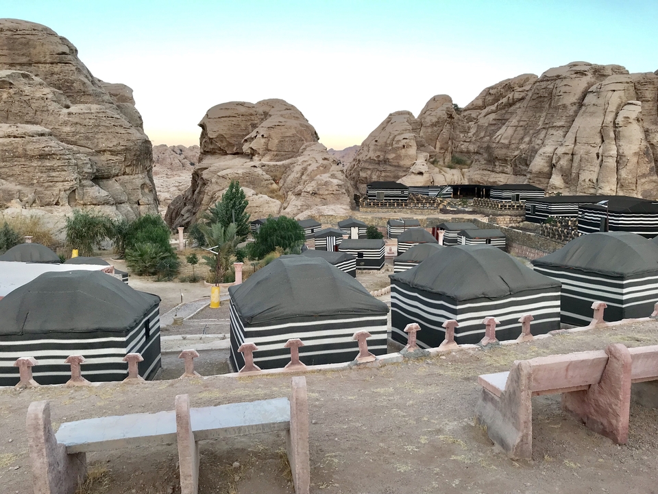 Traditional Bedouin encampment in a rocky area.
