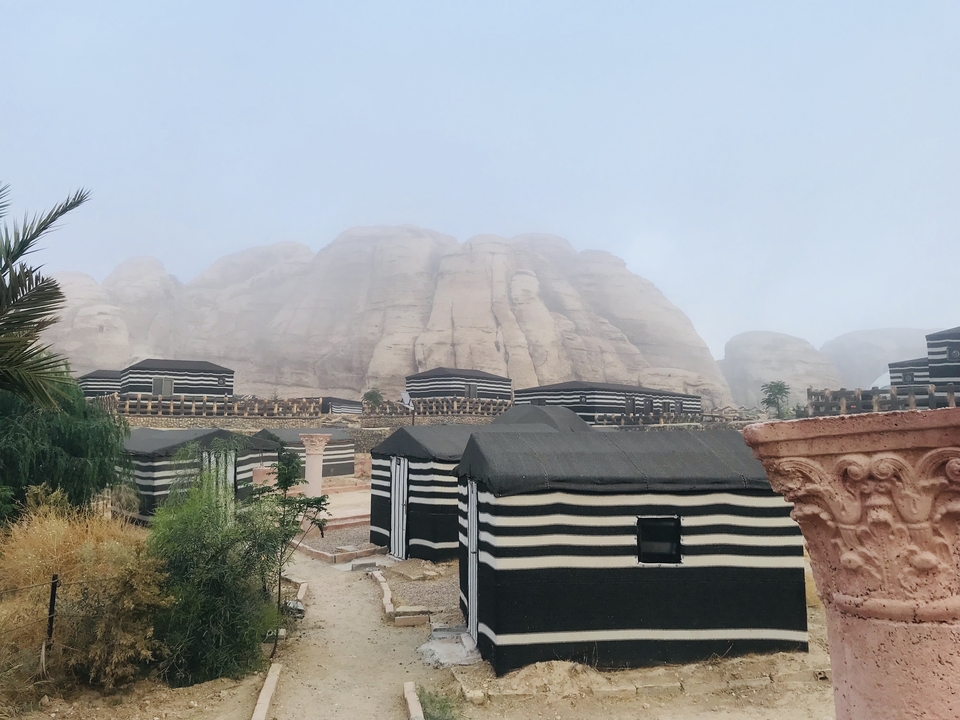 Traditional Bedouin camp against a rocky backdrop.