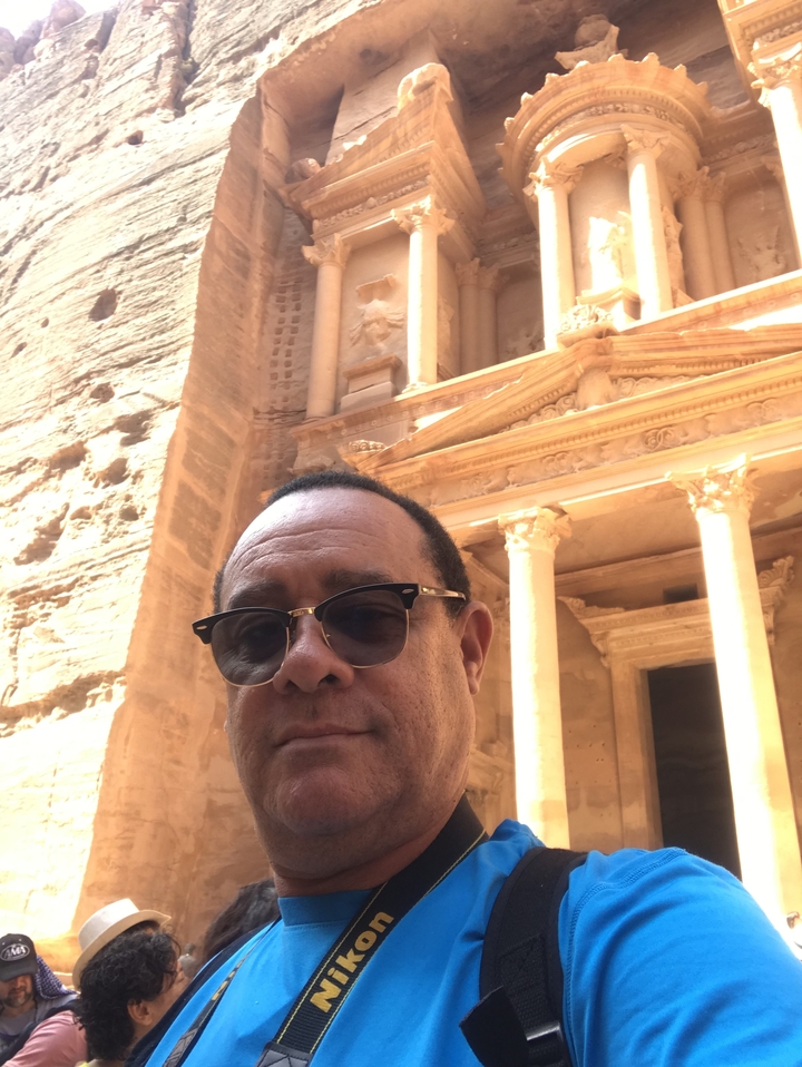 Person taking a selfie in front of an ancient structure.