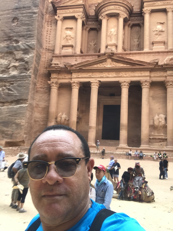 People at the entrance to an ancient site.