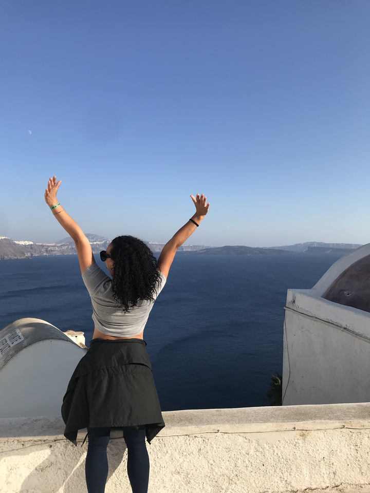 Person enjoying a scenic view over the ocean.