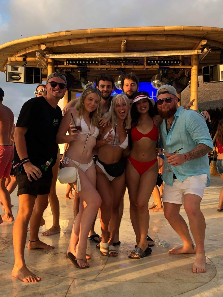 Groupe de personnes dans un bar de plage en train de prendre un verre.