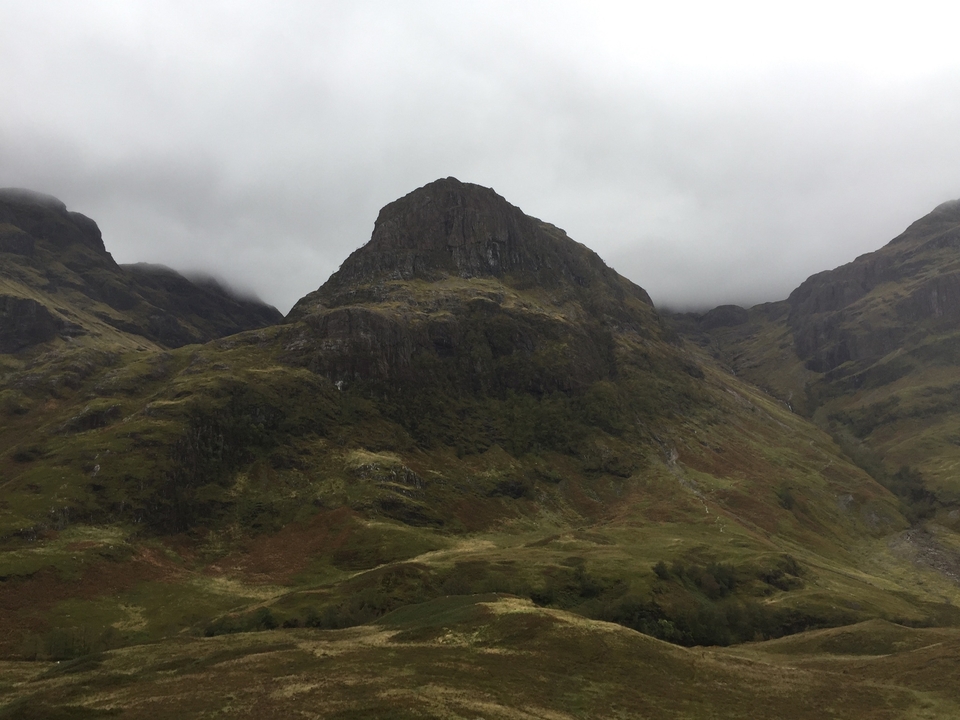 Misty mountain landscape with rugged peaks.