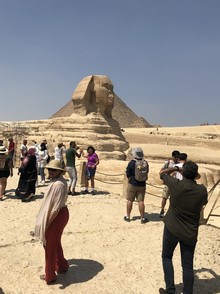 Tourists around the Sphinx in the desert.