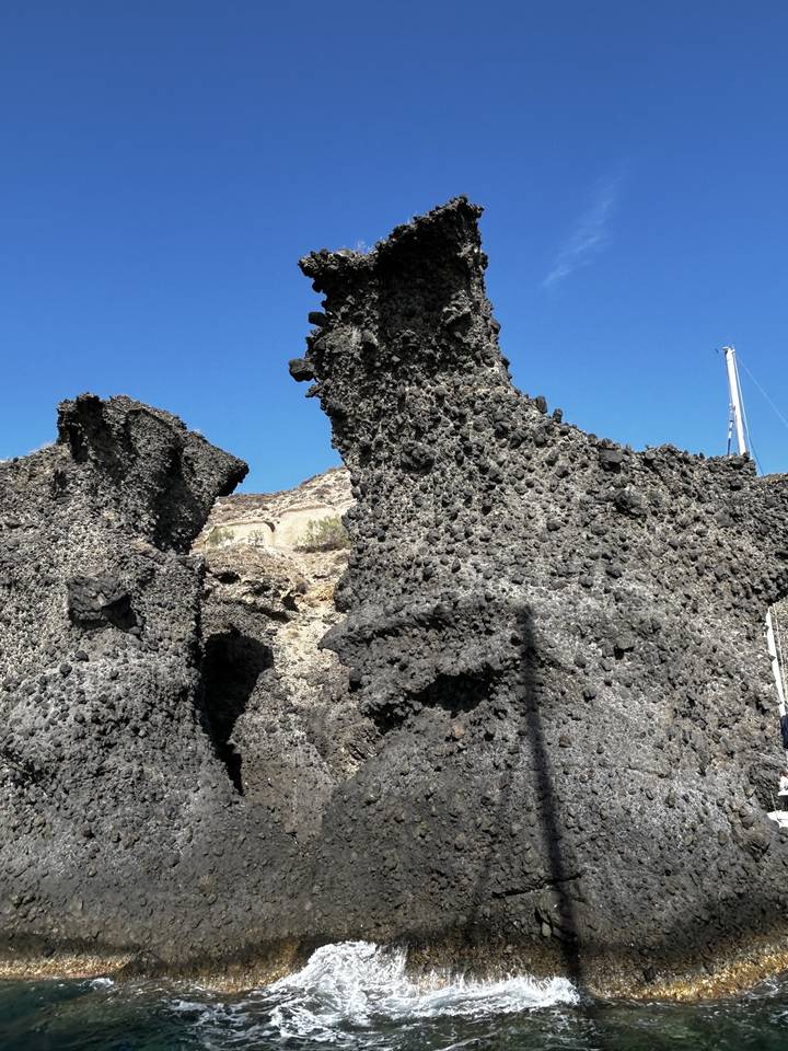 Craggy rock formation against a blue sky.