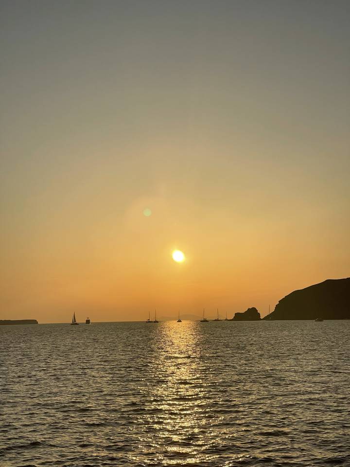 Sunset over the ocean with the sun low on the horizon.