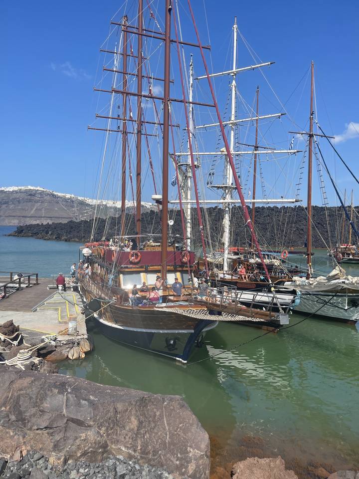 Docked sailboat with a mountainous backdrop.