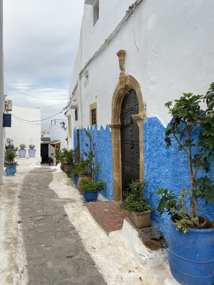 Traditional Moroccan alleyway with blue and white walls.