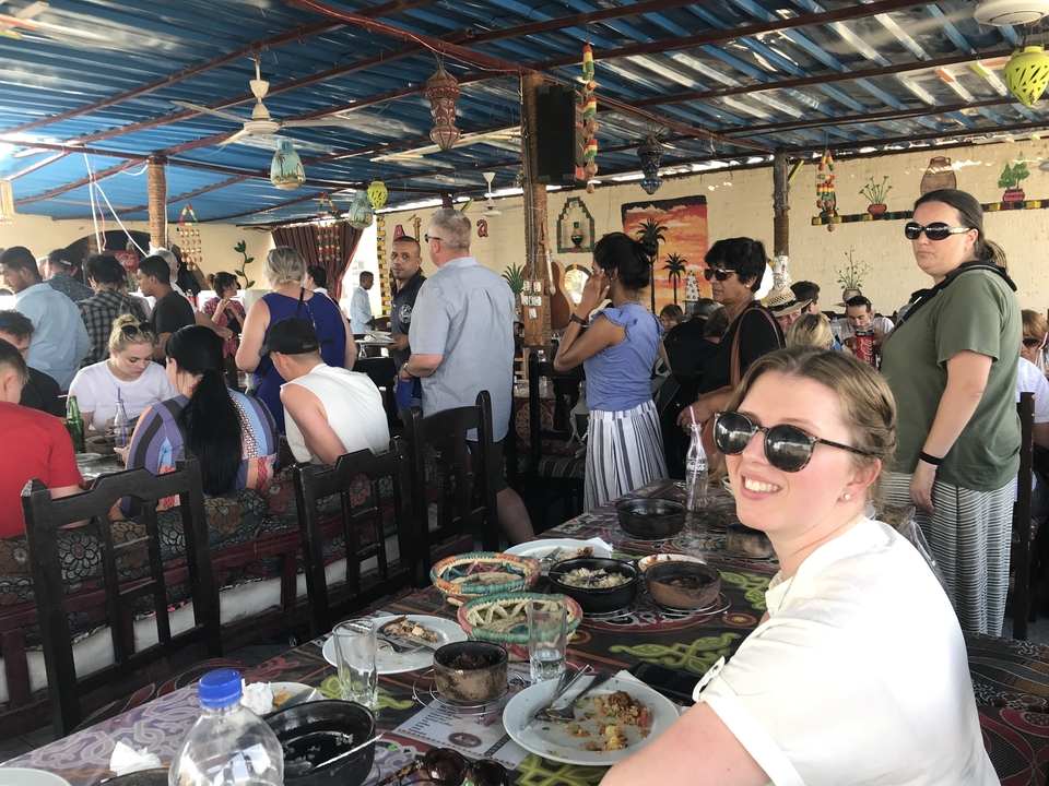 A crowded restaurant with people dining.
