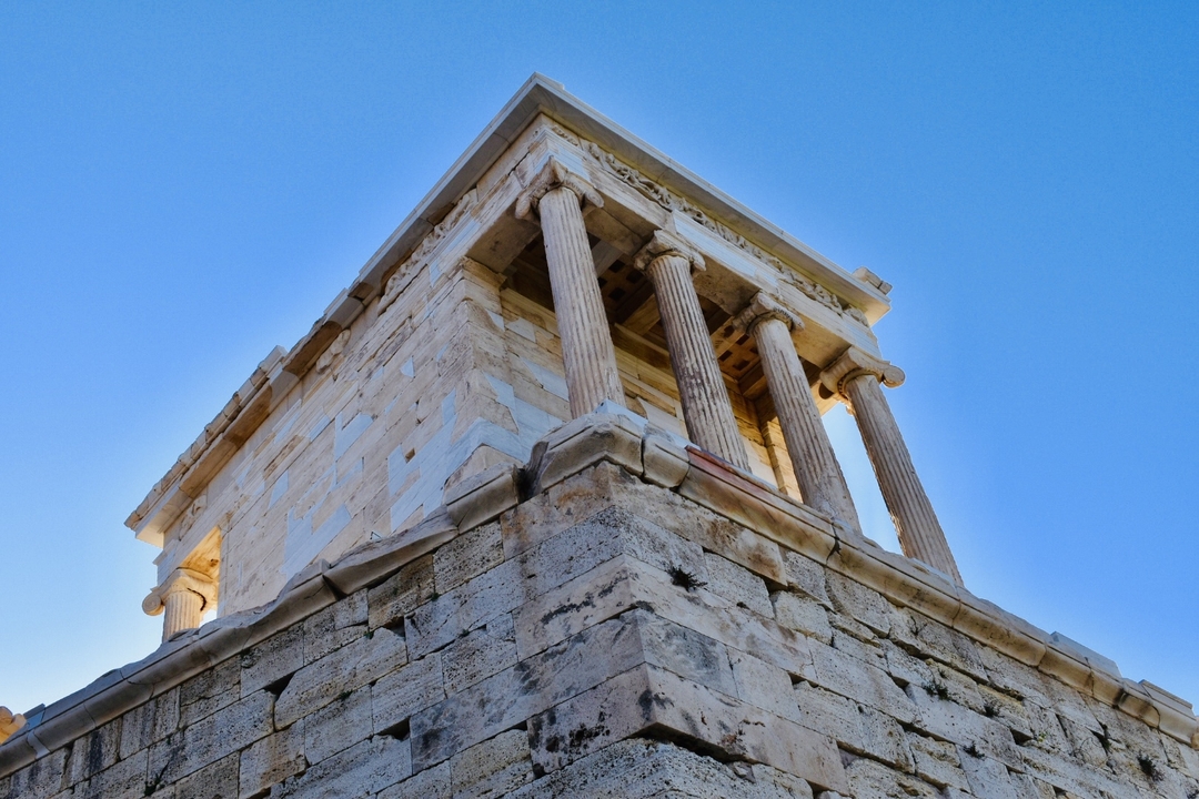 A historical temple corner structure on an elevated stone base