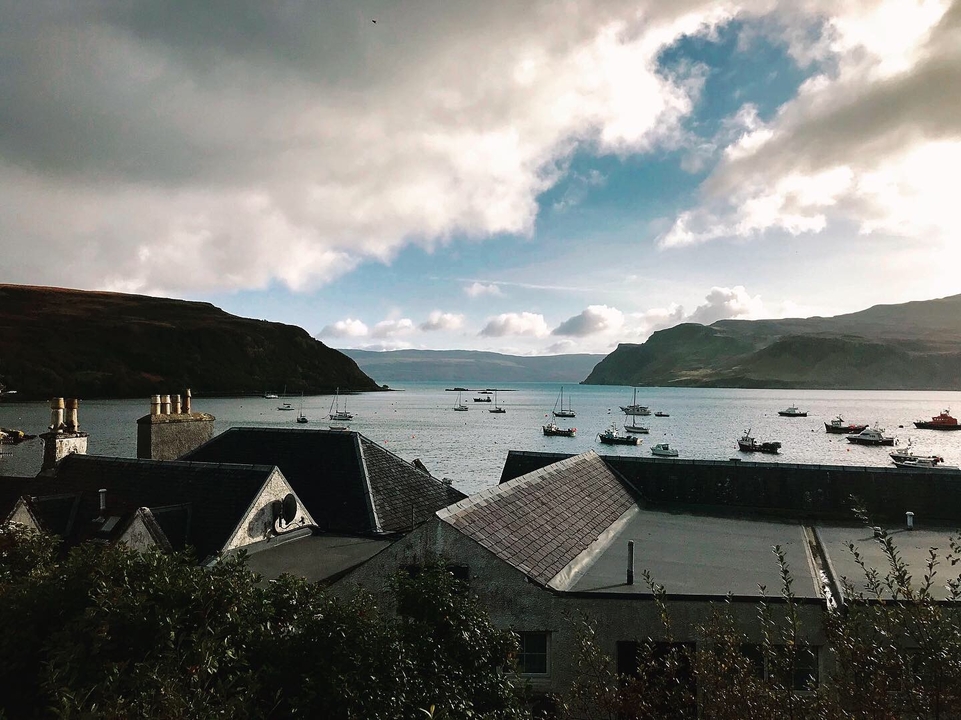 Coastal village view with boats in a bay.