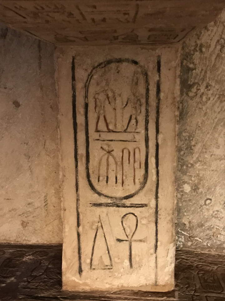 Anciennes gravures sur un mur de pierre montrant des hiéroglyphes.