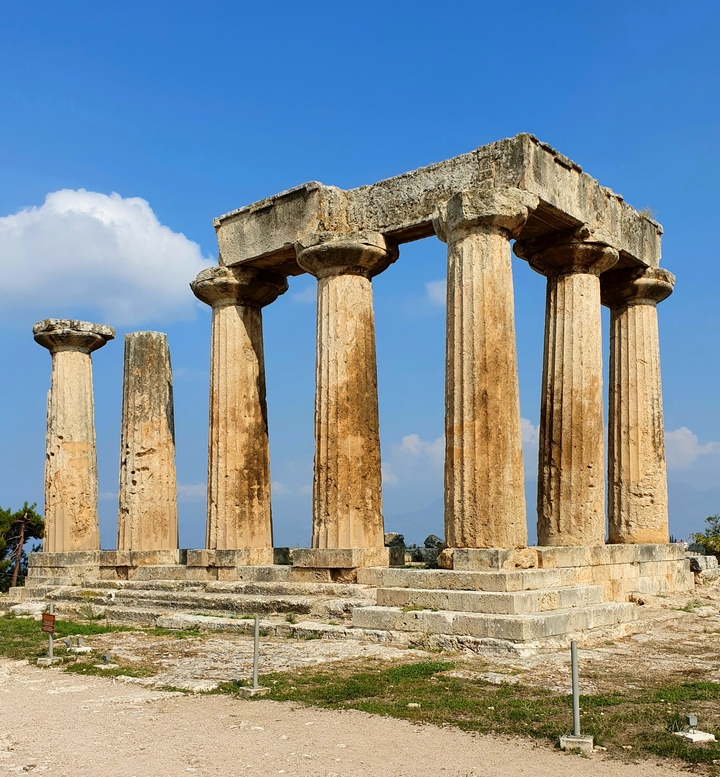 Ruins of ancient columns under a blue sky.