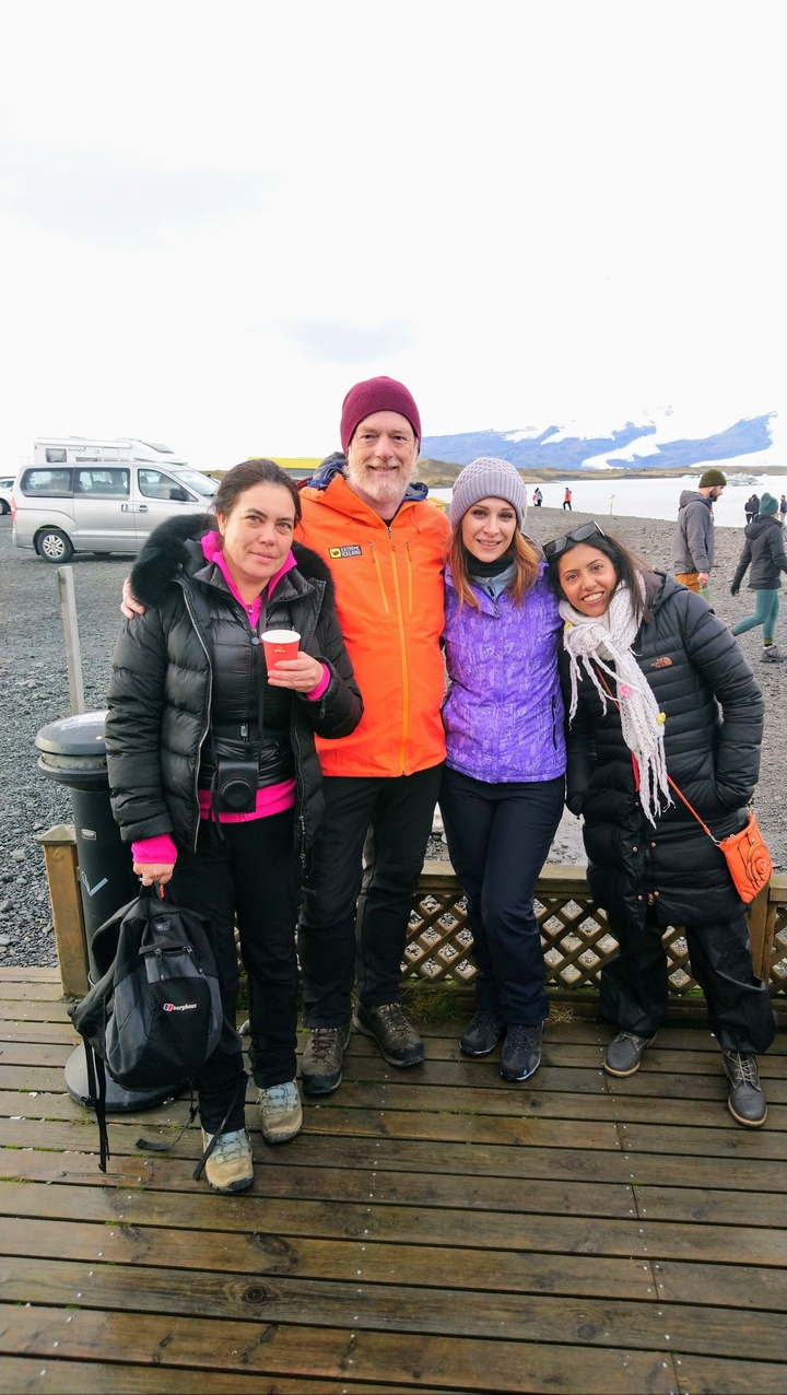 Group of four people outdoors dressed in warm clothing.
