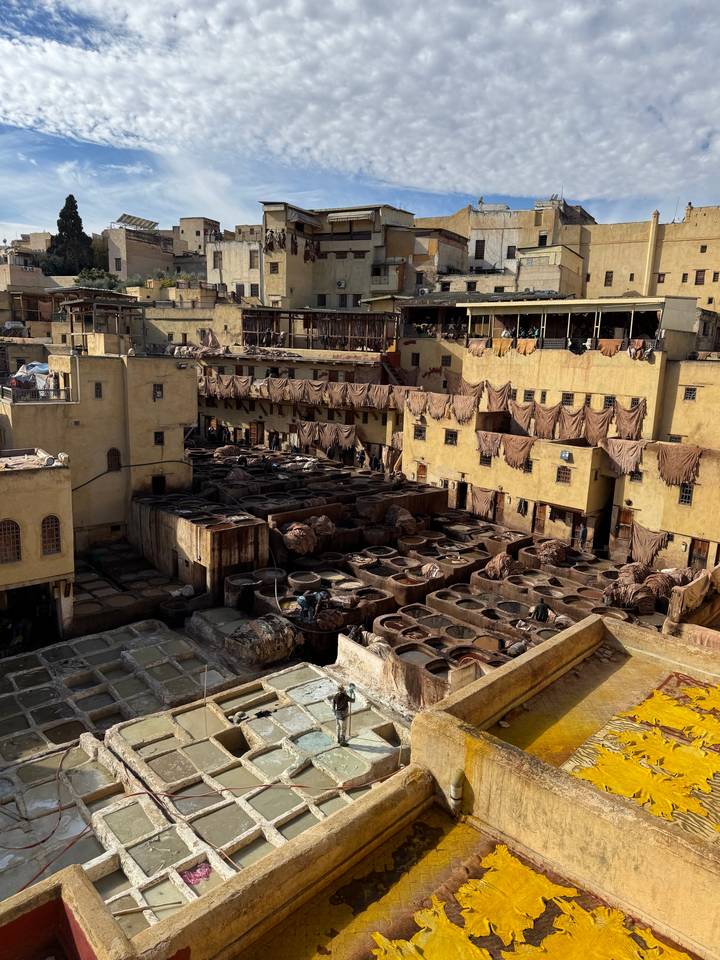 A traditional tannery with tan pits and buildings in a dense, historic area.