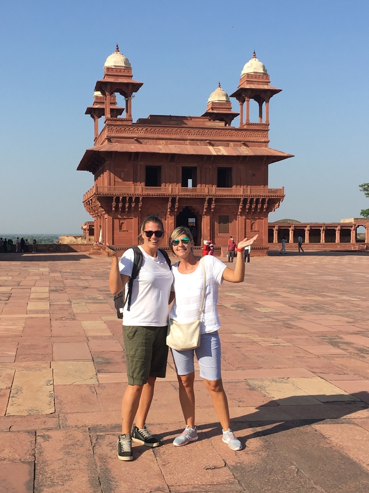 Two people posing in the courtyard of Fatehpur Sikri.