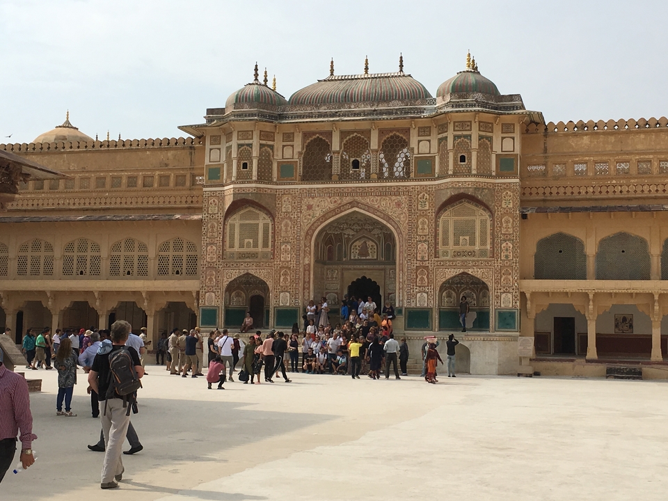 A group visiting a grand historic building with elaborate architecture.