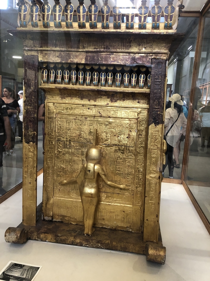 Exquisite golden artifact with hieroglyphs on display.