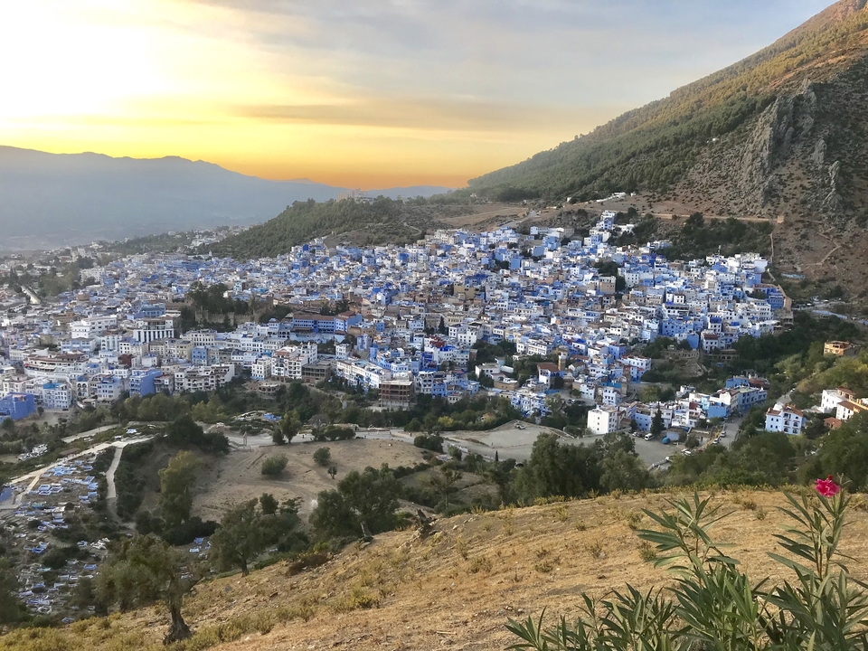 Sunset view of Chefchaouen with blue buildings.
