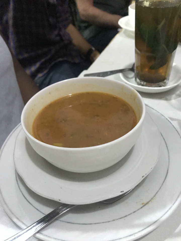 Bowl of soup on a table.