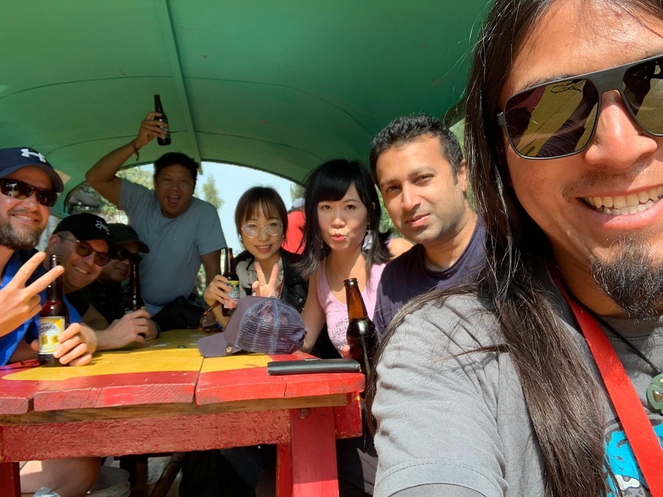 A group of friends on a boat enjoying drinks.