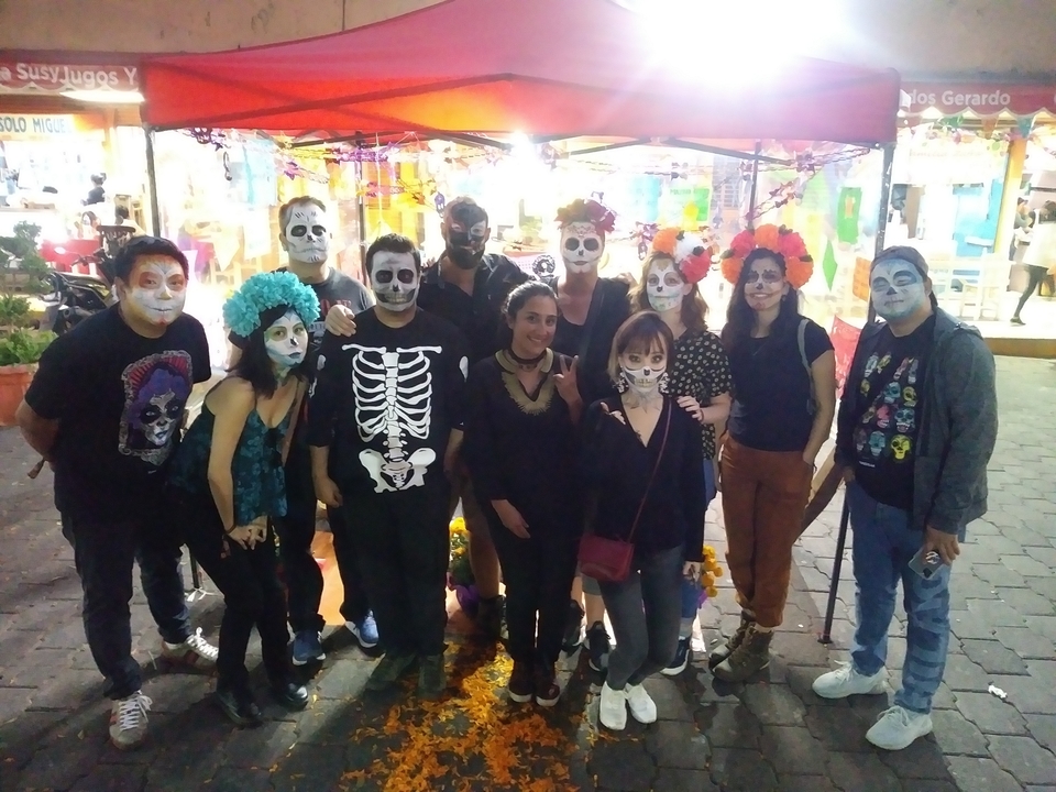 Group of people celebrating with skeletal face paint.