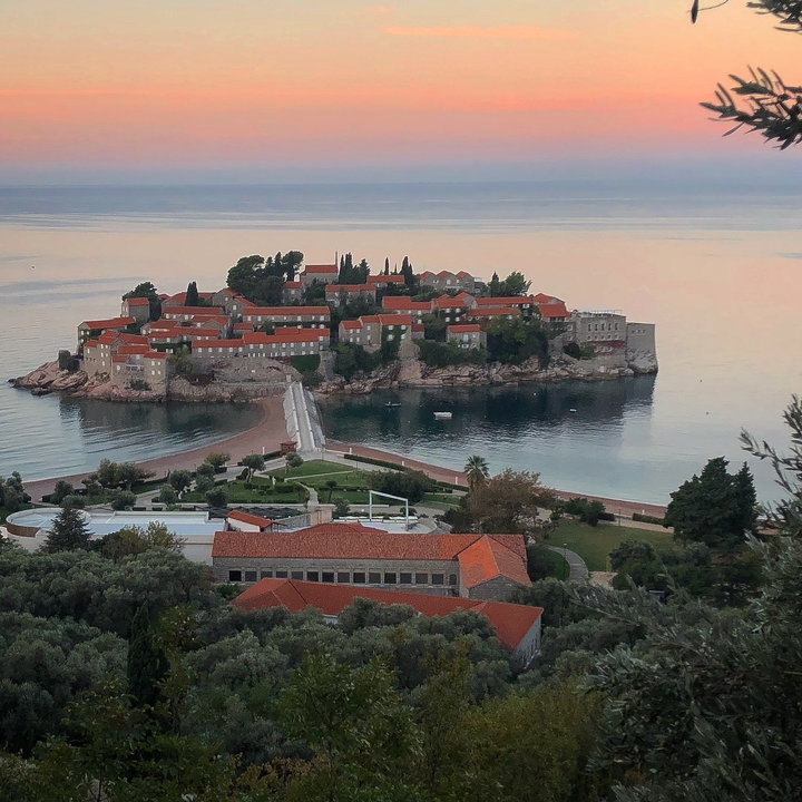 Island with historical buildings connected by a narrow causeway.