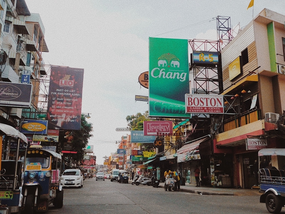 Street view with various signs and buildings.