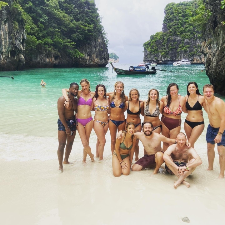 Group of people posing on a tropical beach.