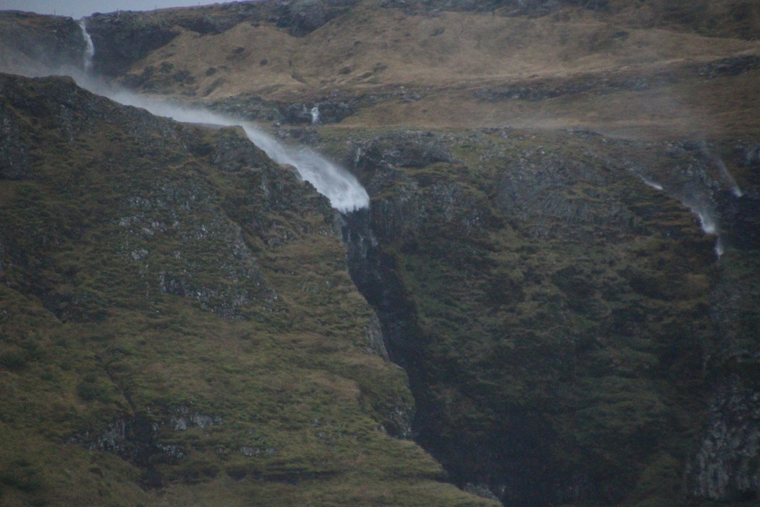 Remote waterfall in a rugged mountain landscape.