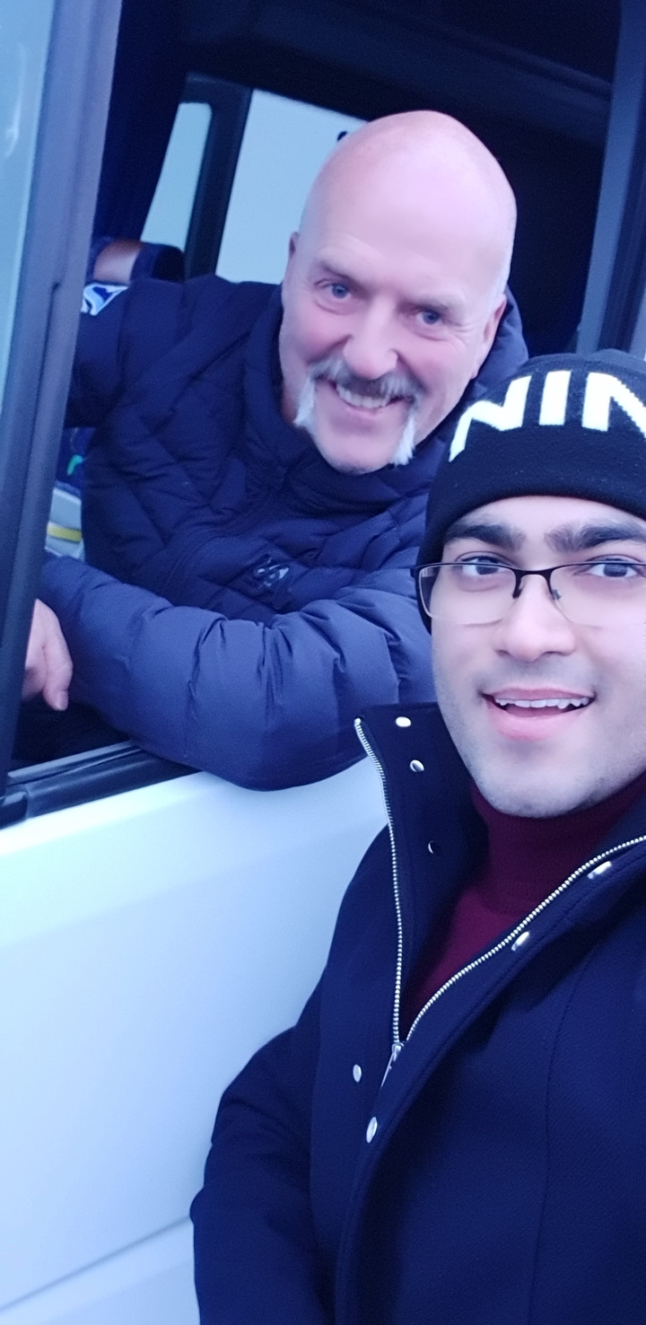 Close-up of a person in a car wearing a winter jacket.