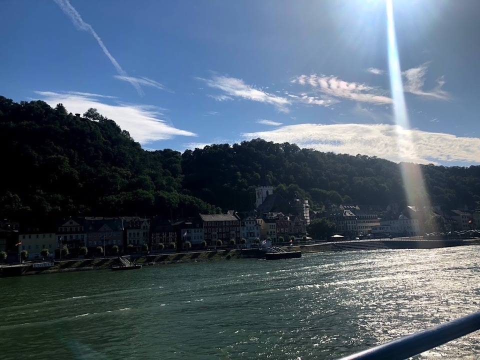 Riverside town with scenic hills in the background.