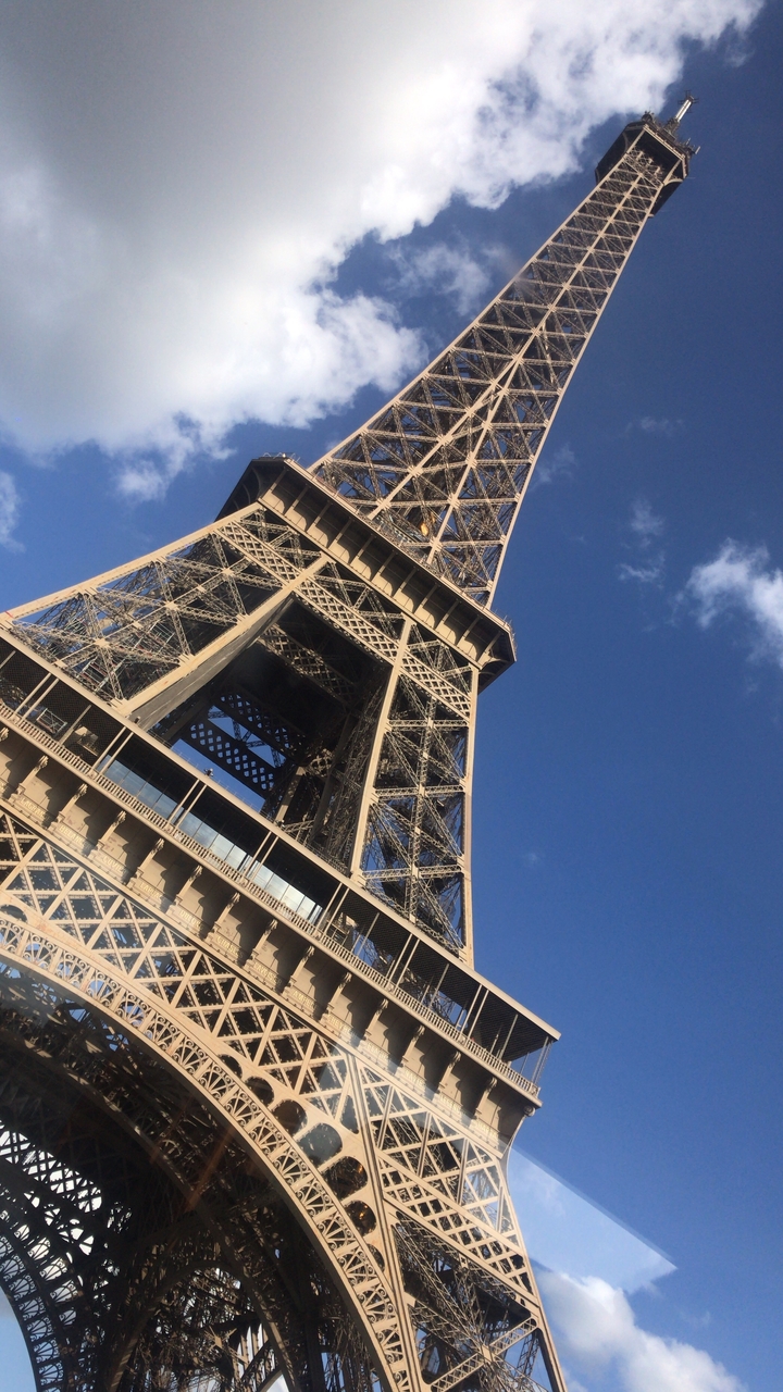 Close-up shot of the Eiffel Tower with clear blue sky.