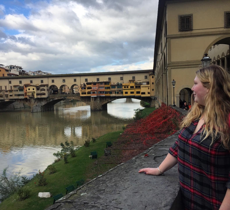 Person looking at the Ponte Vecchio in Florence.