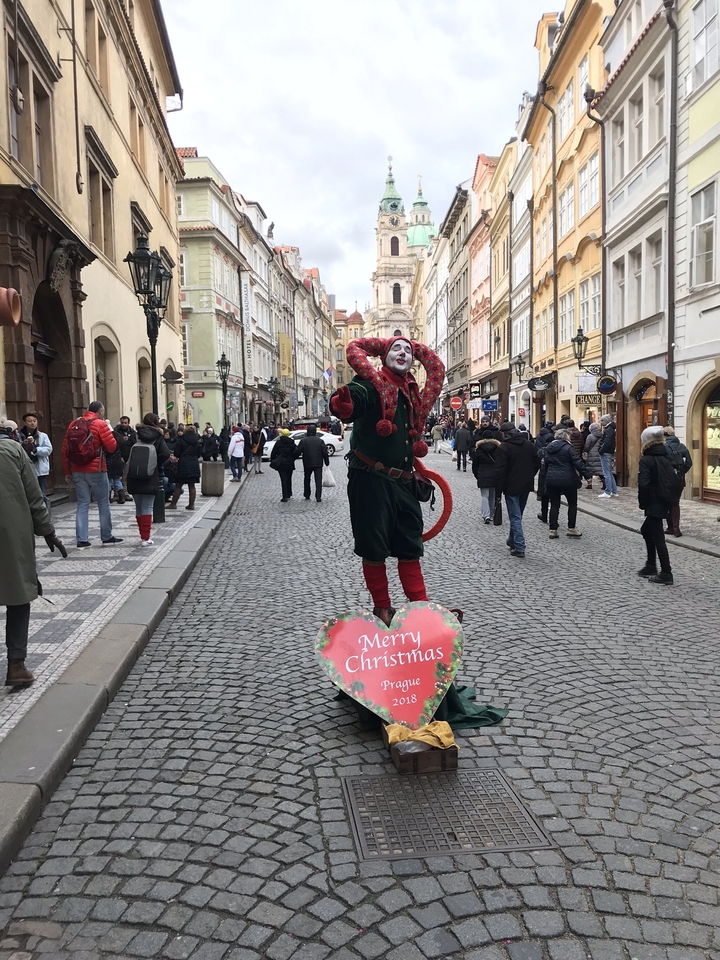 Street performer dressed as a jester during Christmas.