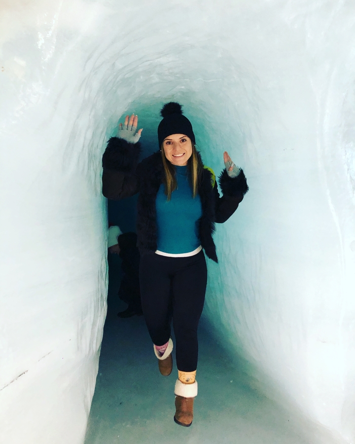A person in a narrow icy tunnel.