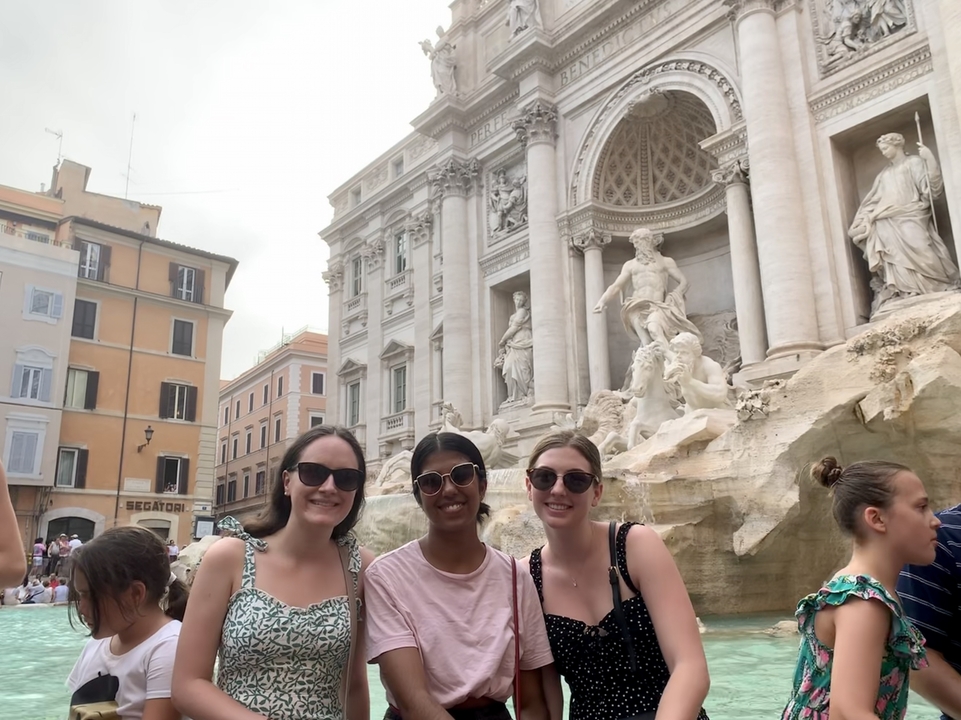 Group of friends in front of the Trevi Fountain.