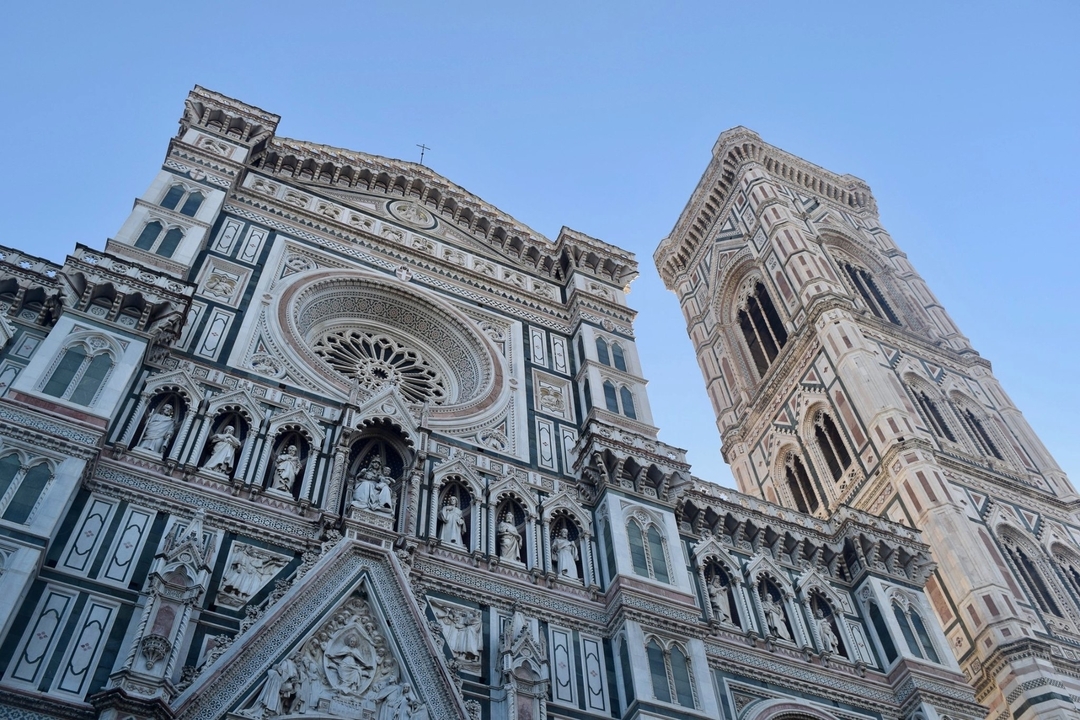 Intricate facade of a historic cathedral with a bell tower.