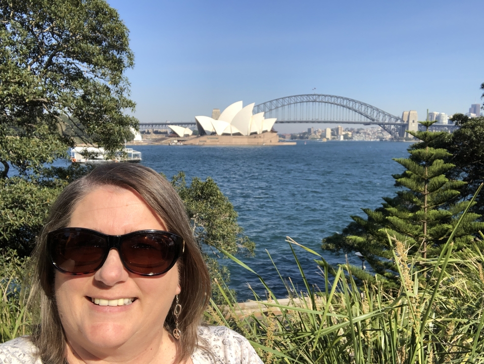 Personne prenant un selfie avec l'Opéra de Sydney et le Harbour Bridge en arrière-plan.