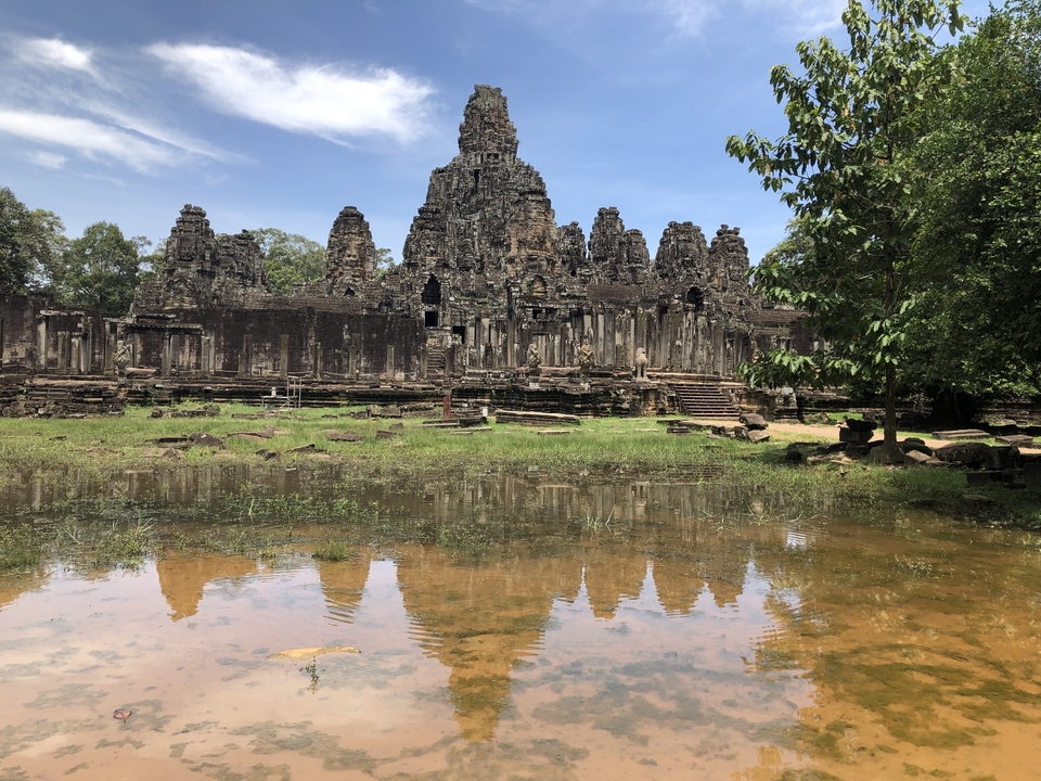 Reflection of ancient temple ruins in a pond.