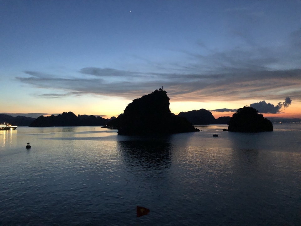 Scenic view of ocean and islands at sunset.
