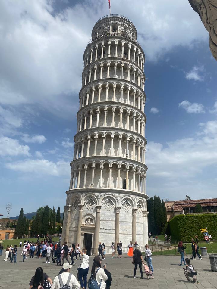 Leaning Tower of Pisa with tourists walking around.