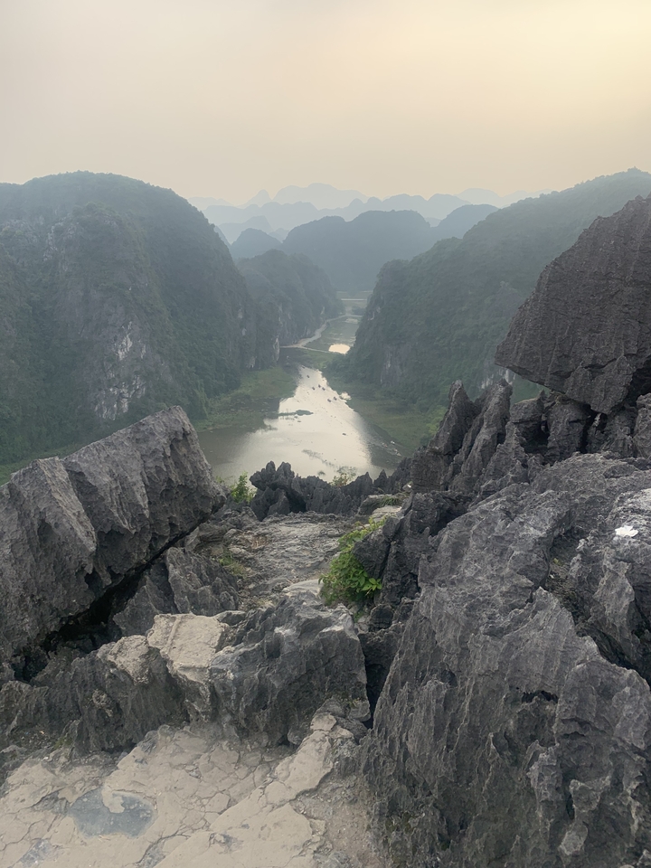View from a rocky summit overlooking a winding river valley.