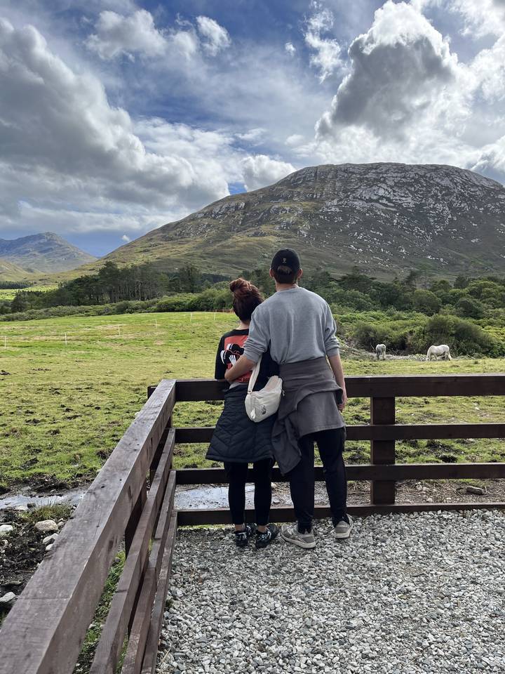 Couple on a wooden platform looking at the scenery.